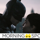 Batman and Catwoman share a moment on a Gotham City rooftop.